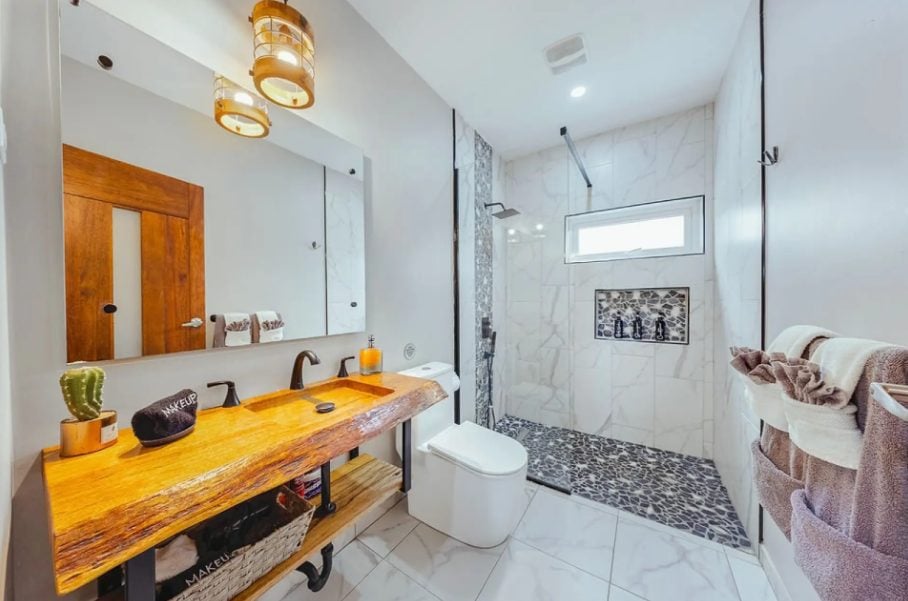 Bathroom with wooden vanity and walk-in shower