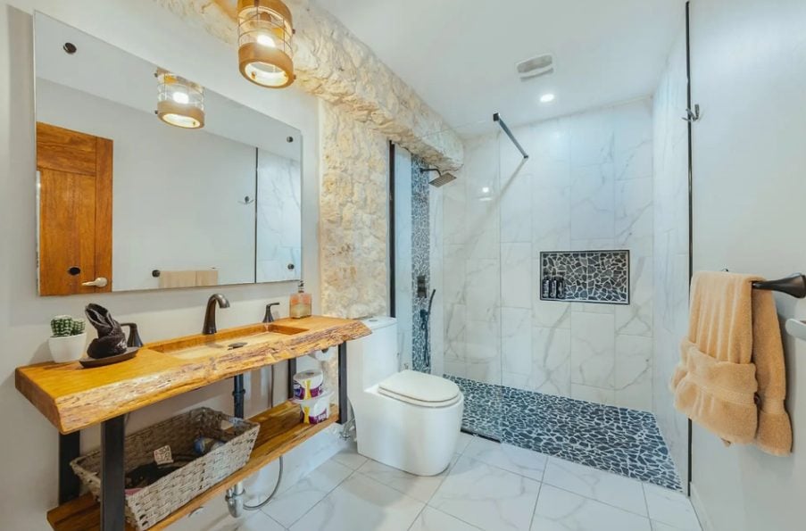 Bathroom with wooden vanity and walk-in shower