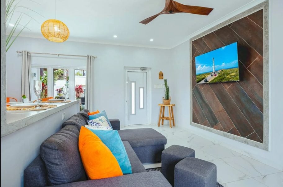 Living area with sofa and orange cushions