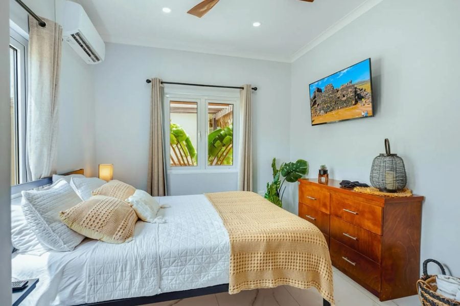 Bedroom with white bedding and wall art